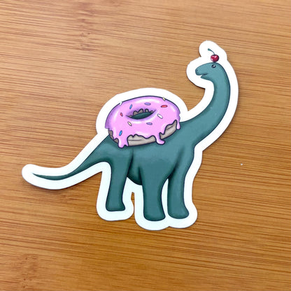 baby brachiosaurus with a donut 3” glossy vinyl laptop water bottle sticker decal